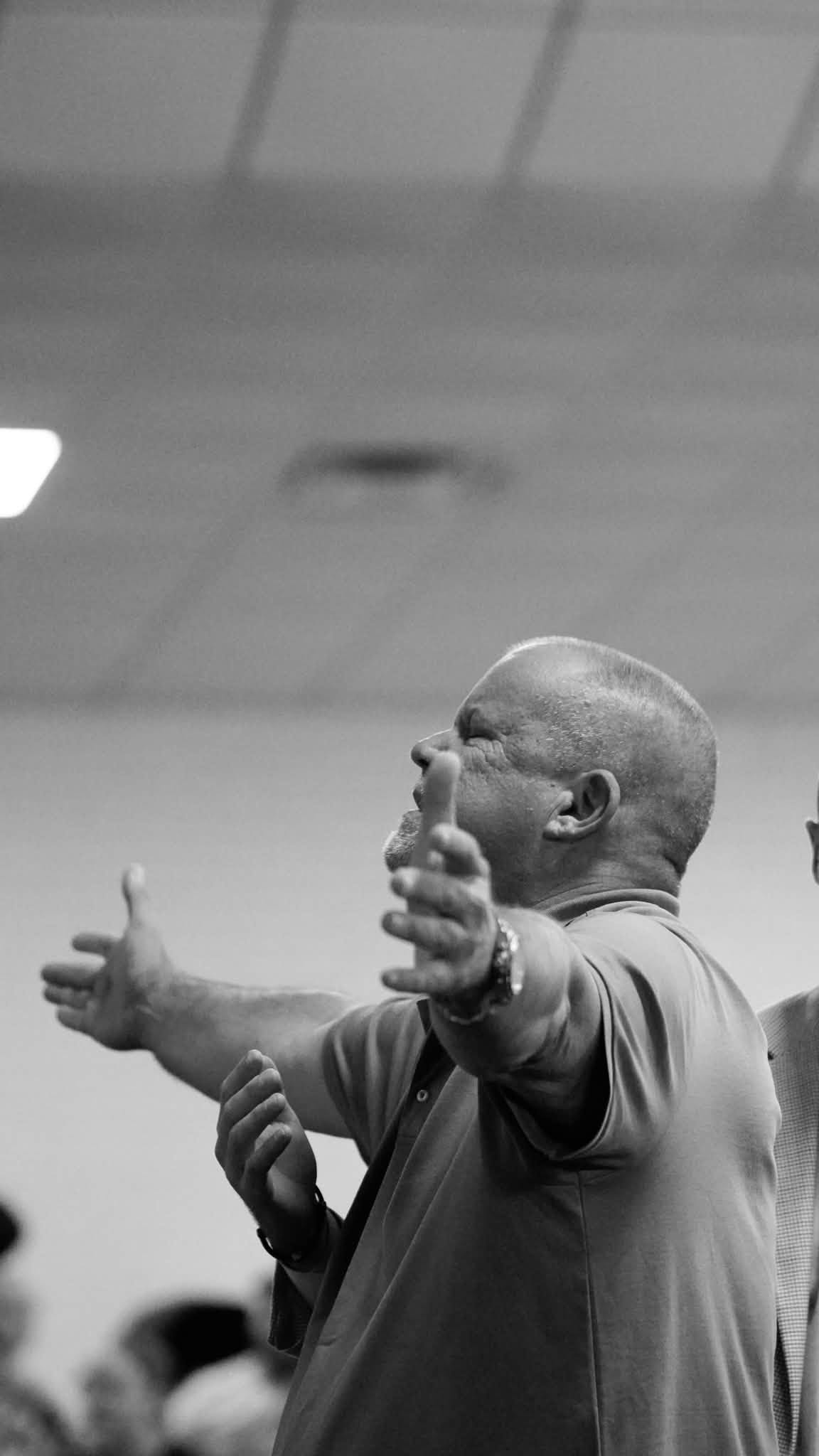 A man worshipping with his arms outstretched