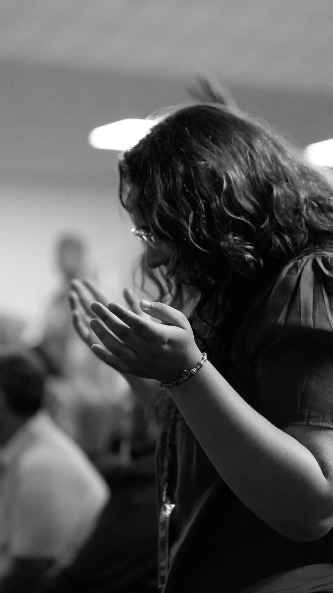 A woman with her hands lifted during worship