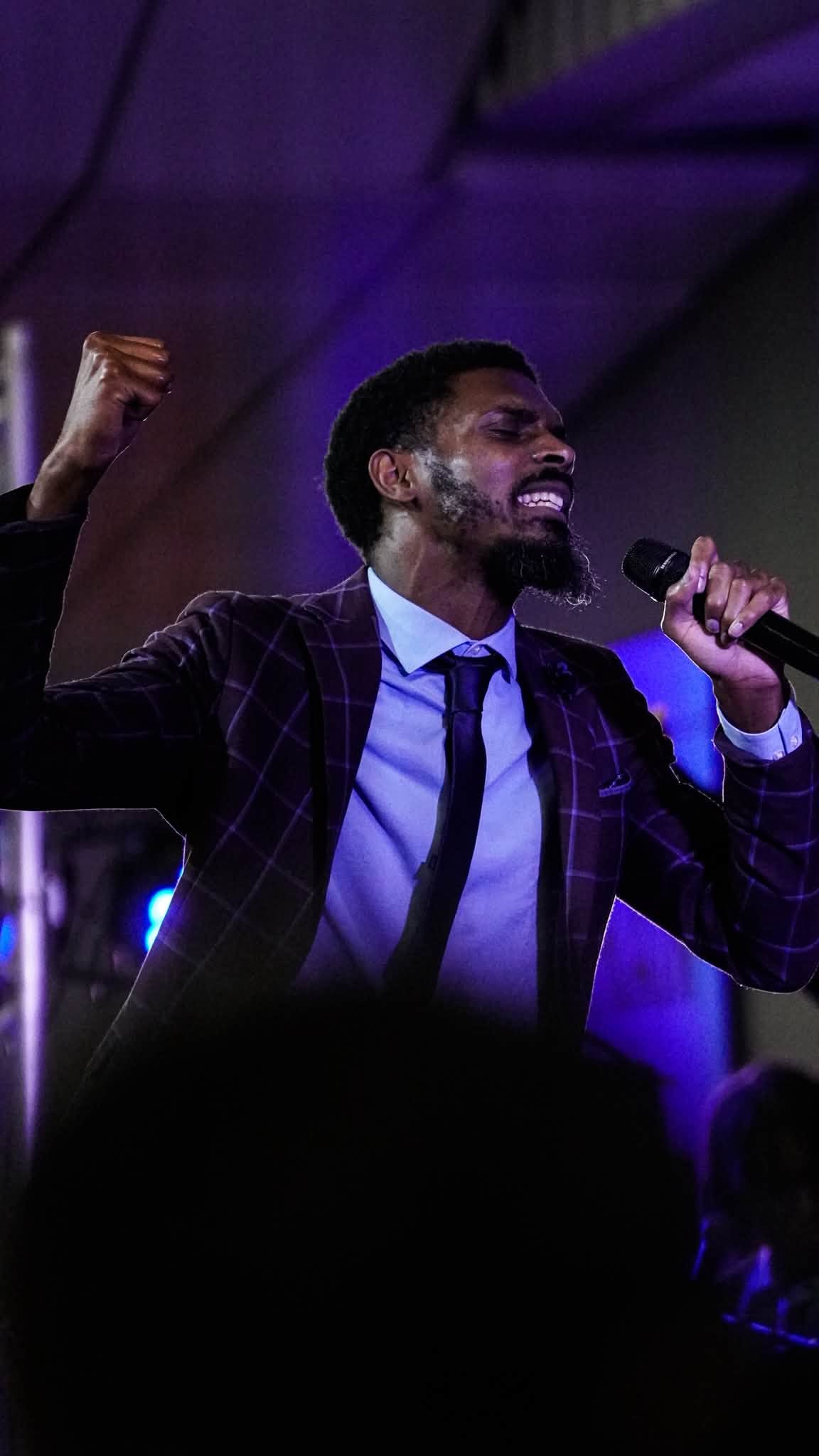 A singer leading worship with a microphone