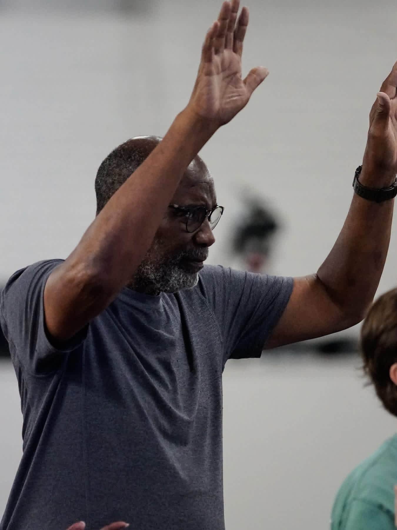 A man lifting both hands in worship